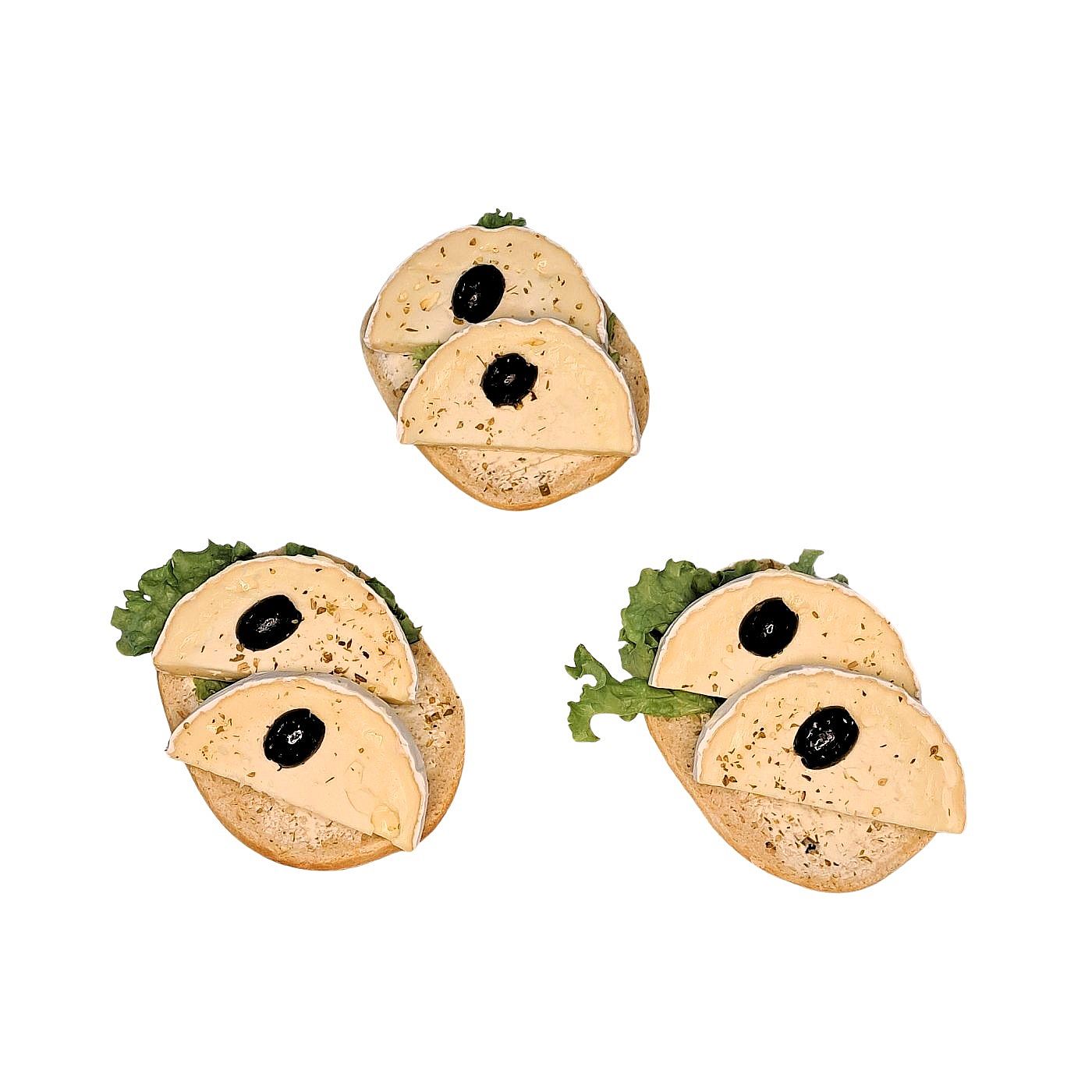 Halbes Brötchen mit Camembert, Oregano und marinierten Oliven